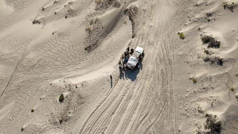 Drone view of off-road SUV stuck in desert dunes. Sokotra, Yemen. Stock Photos