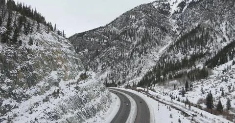 Drone view of a Road Through Snow-Covered Mountains Stock Photos