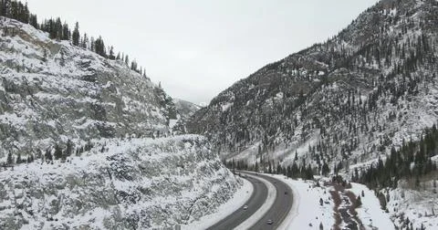 Drone view of a Road Through Snow-Covered Mountains Stock Photos
