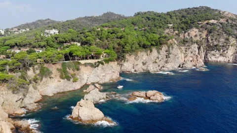 Drone view of rocky cliffs and the sea in the city of Tossa de Mar Stock Footage 165325310