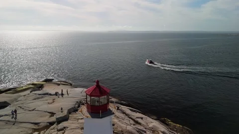 Drone view of rocky coast with lighthouse and lobster fishing boat Peggy's Cove Vídeo Stock 275200640