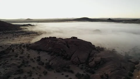 Drone view of rocky desert landscape with morning fog Stock Footage 315957825