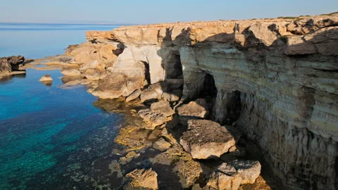 Drone view of a rocky opening and sea cave entrance at Cape Cavo Greco. Stock Footage 341541655