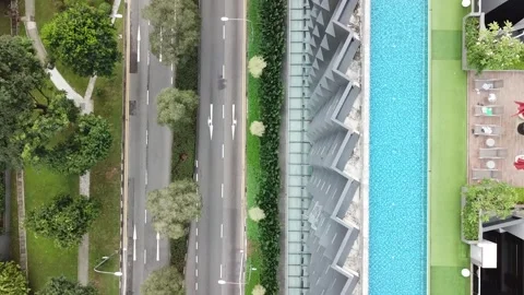 Drone view of rooftop infinity pool on a modern building in Singapore 스톡 동영상 157469014