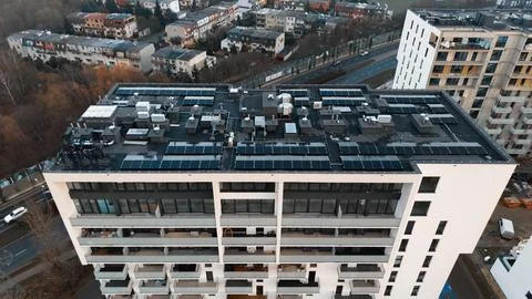 Drone view of rooftop solar panels and HVAC system on modern apartment building Stock Photos
