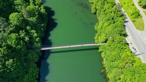 Drone view Rope Bridge over Pasarel dam, water reflection, autumn trees Stock Footage 256034454