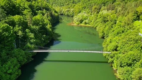 Drone view Rope Bridge over Pasarel dam, water reflection, autumn trees Stock Footage 256034466