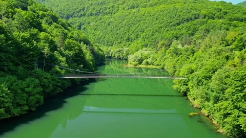 Drone view Rope Bridge over Pasarel dam, water reflection, autumn trees 스톡 동영상 256034483