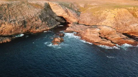 Drone view rotating around a rocky seaside of belle ile en mer at sunset Stock Footage 164580357