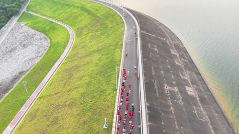 Drone view of runners on reservoir dam Stock-Footage 341738548
