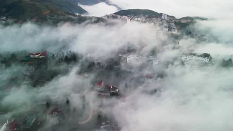 Drone View of Rural Mountain Settlement Surrounded by Dense Fog in Northern Stockbeeldmateriaal 333110525