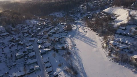 A drone view of a Russian village in winter. Frozen lake Stock Footage 236013487