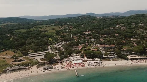 Drone view of saint tropez beach. people relaxing under red sun loungers Stock Footage 309536790