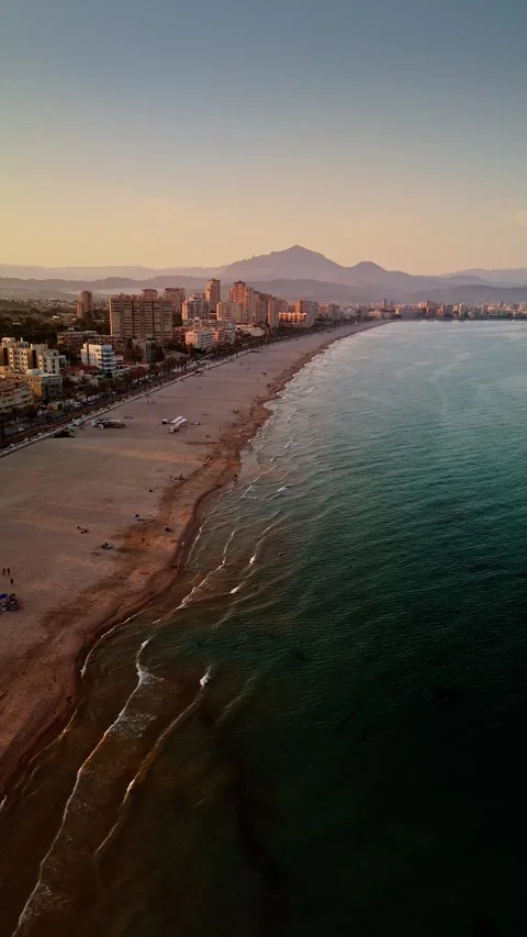Drone view of San Juan beach and city skyline at sunset Stock Footage 311065148