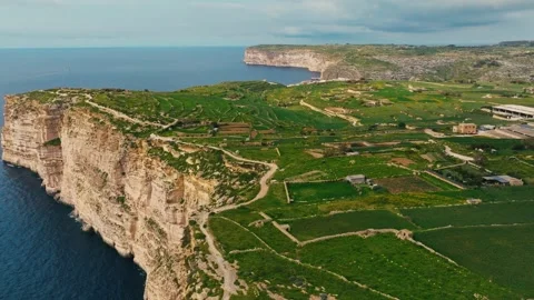 Drone view of Sanap Cliffs, Gozo island. Green fields, rocks and cliffs, sea Video stock 329990067