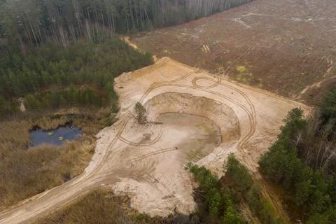 Drone view sand pit in the middle of the forest rural landscape. Stock Photos