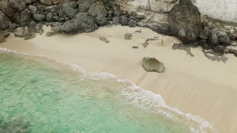 Drone view of sandy beach and ocean with waves. Balangan Beach on Bali Stock Footage 136780099