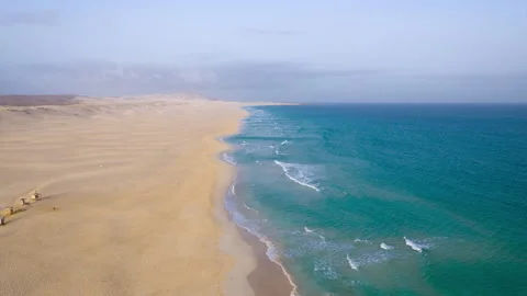 Drone view of sandy beach turquoise ocean and background clouds Stock Footage 325448382