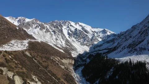 Drone view of scenery mountain peaks covered by snow Видео 236863147