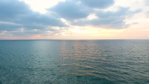 Drone View Of Sea Wave Breaking At Sunset, Sun Shining On Water v1 Stock Footage 100128702