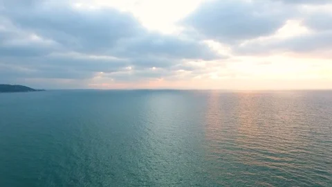 Drone View Of Sea Wave Breaking At Sunset, Sun Shining On Water v2 Stock Footage 100128871