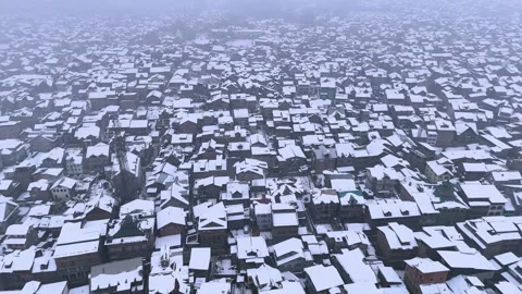 Drone view of serene snow-covered houses in the heart of Kashmir Stock Footage 310223810
