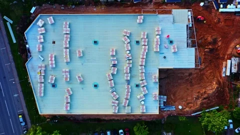 Drone view showing building materials stocked on a flat roof during warehouse Stock Footage 335185635