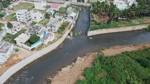 A drone view shows Bengalurus large drainage canal overflowing with filthy .. Stock Footage 329313059