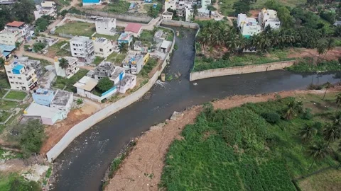 A drone view shows Bengalurus large drainage canal overflowing with filthy .. Stock Footage 329313062