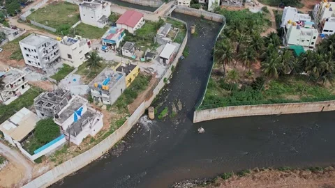 A drone view shows Bengalurus large drainage canal overflowing with filthy .. Video stock 329313083