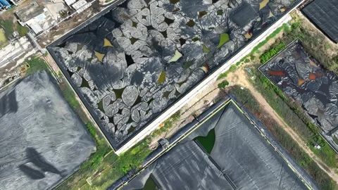Drone view shows multiple lined waste containment ponds. Stock Footage 306899608