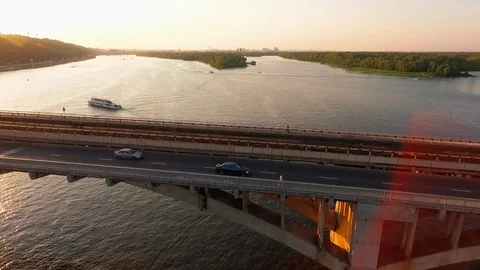 Drone view Side view car rides over the bridge at sunset Video stock 111874933