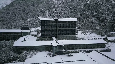 Drone view of ski resort hotel with snowy mountain background in New Zealand Stock Footage 121598548
