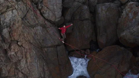 Drone view of slacklining on a Tightrope and Man keeping Balance Stock Footage 264052860