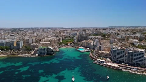 Drone view of Sliema's turquoise bays with boats and urban architecture Stock Footage 336469417