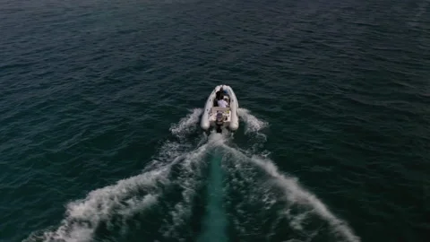 Drone View of Small Inflatable Raft Boat Passing Over Clear Ocean Water Stock Footage 169331599