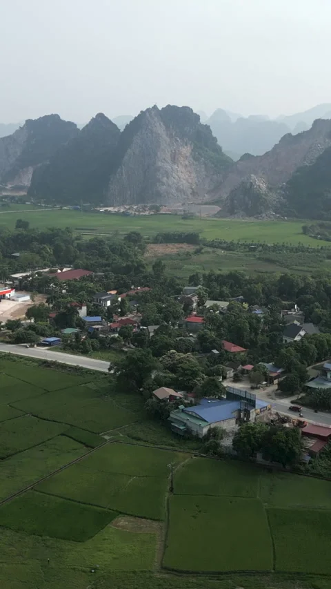 Drone view of small town and gas station surrounded by a road near crop fields Stock Footage 278246944