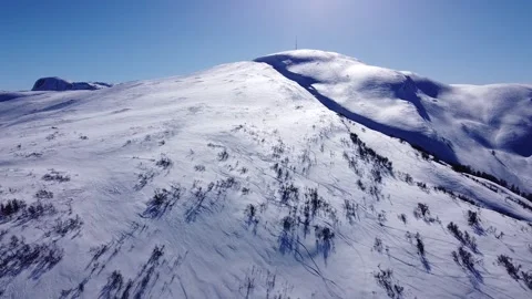 Drone View of a Snow Covered Vikafjell, Norway. Aerial view with blue sky Stock Footage 234515826