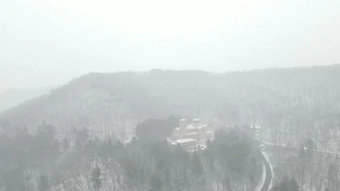 Drone view of snow falling over mountainside church in Wisconsin. Stock Footage 166259247