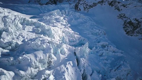 Drone view snowy mountain with ice crater formations on sunny day in New Zealand Stock Footage 121600321