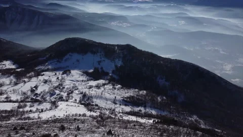 Drone view of snowy mountain landscape on a winter sunny day Stock Footage 169543596
