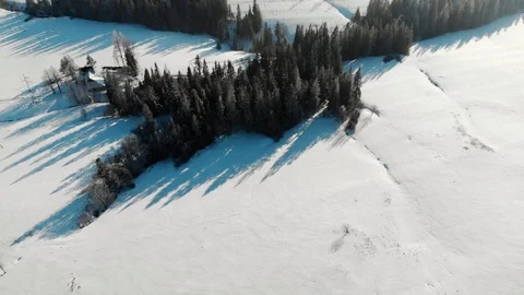 Drone view of snowy valley in mountains with trees in haze and bright sunlight 스톡 동영상 105686507