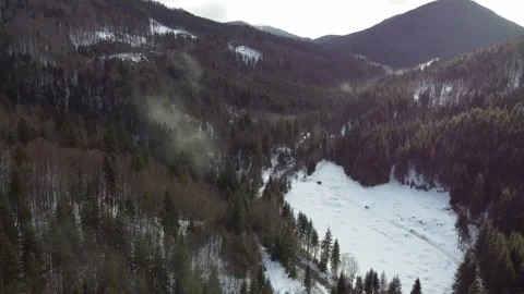 Drone View of Snowy Valley Surrounded by Mountainous Terrain Stock Footage 324622081