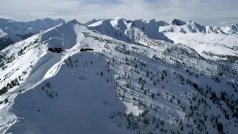 Drone view of Snowy winter mountains with clouds moving in sky during day time Stock Footage 121576442