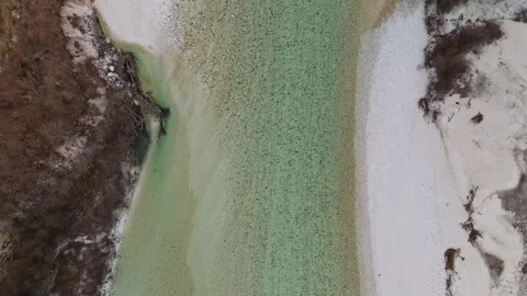 Drone view of Soča River near Žaga flowing through winter forest landscape Video stock 340588223