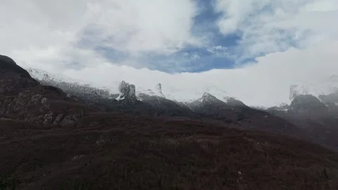 Drone view of Soča Valley, snowy Julian Alps and cloudy winter sky above Video stock 340588299