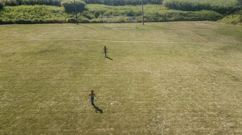 Drone view of a soccer field with two children playing Foto stock