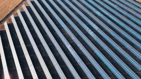 Drone view of solar power panels on black autumn fields at sunset. Aerial view. Stock Footage 166844403