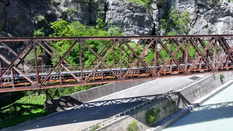 Drone view of some cyclist over a iron bridge in the mountain Stock Footage 263384324