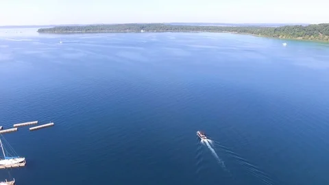 Drone view of a speed boat heading out to Lake Michigan Stock Footage 102412747
